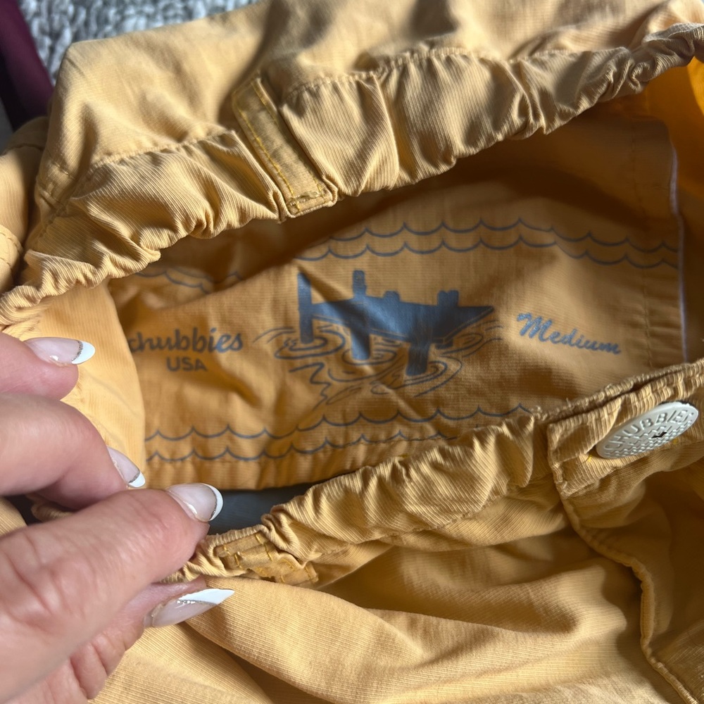 Three pairs of swim trunks sizes, small, XS and Med